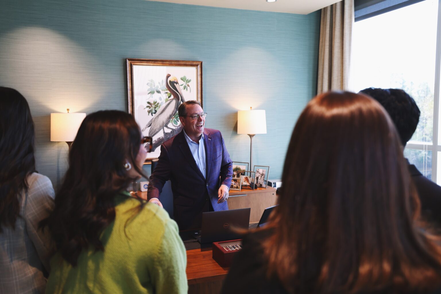 Chancellor Hodges spends intentional time with a group of students in his office.